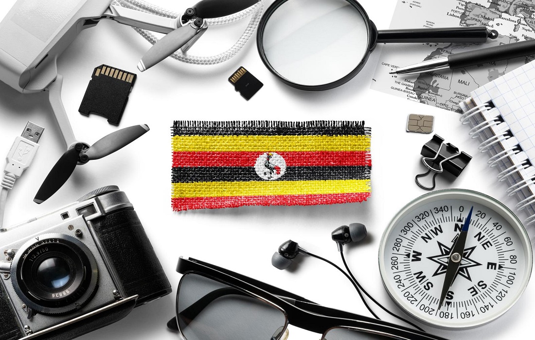 flag-of-uganda-and-travel-accessories-on-a-white-background