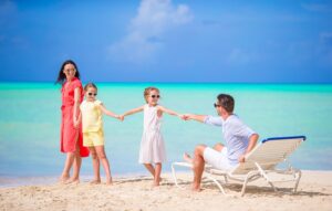 Happy-beautiful-family-on-white-beach-having-fun